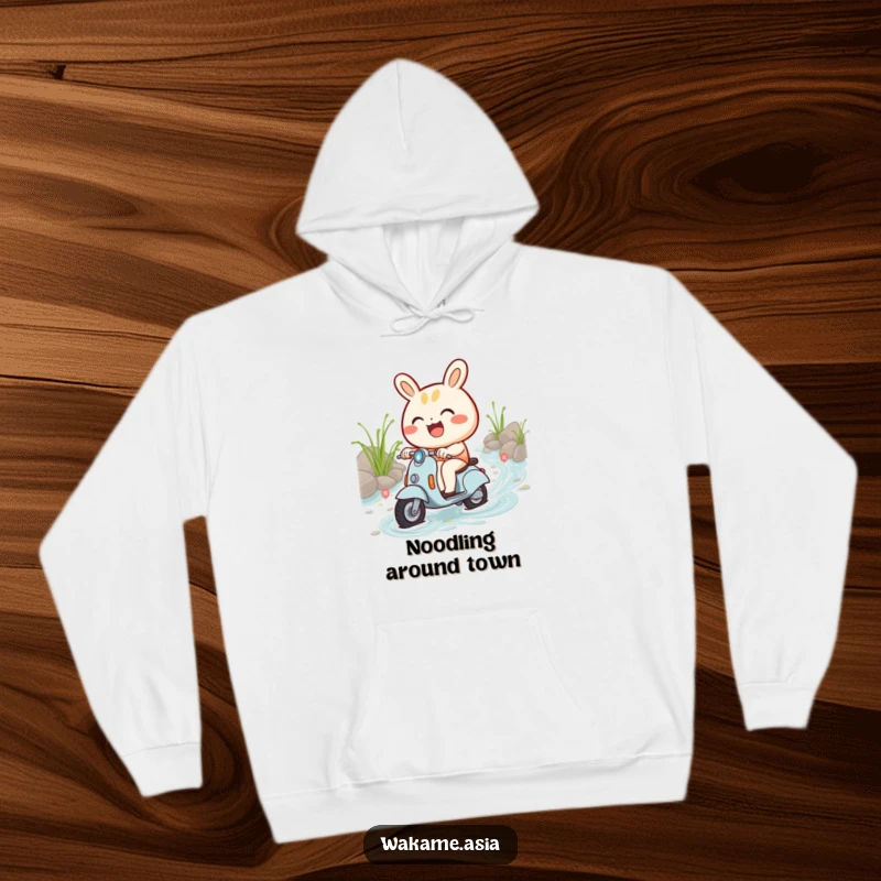Funny hoodie illustrating a smiling bao bun character riding a miniature scooter amidst a flowing stream of noodles.